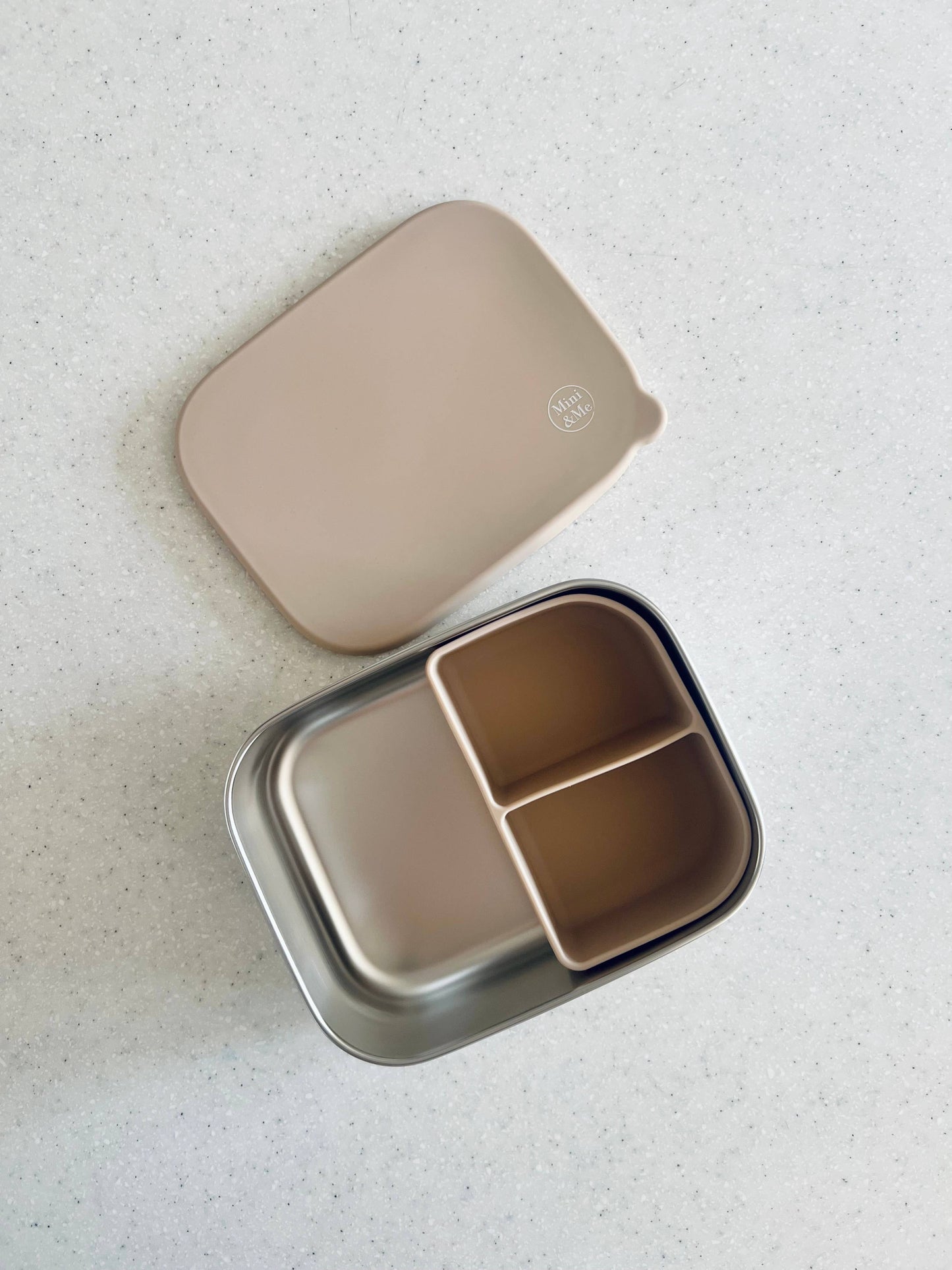 A peaceful moment featuring the Stainless Steel Bento Box with Silicone Divider Almond as part of a mindful daily routine.