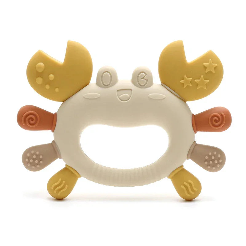 Baby using crab-shaped teether for teething relief and play