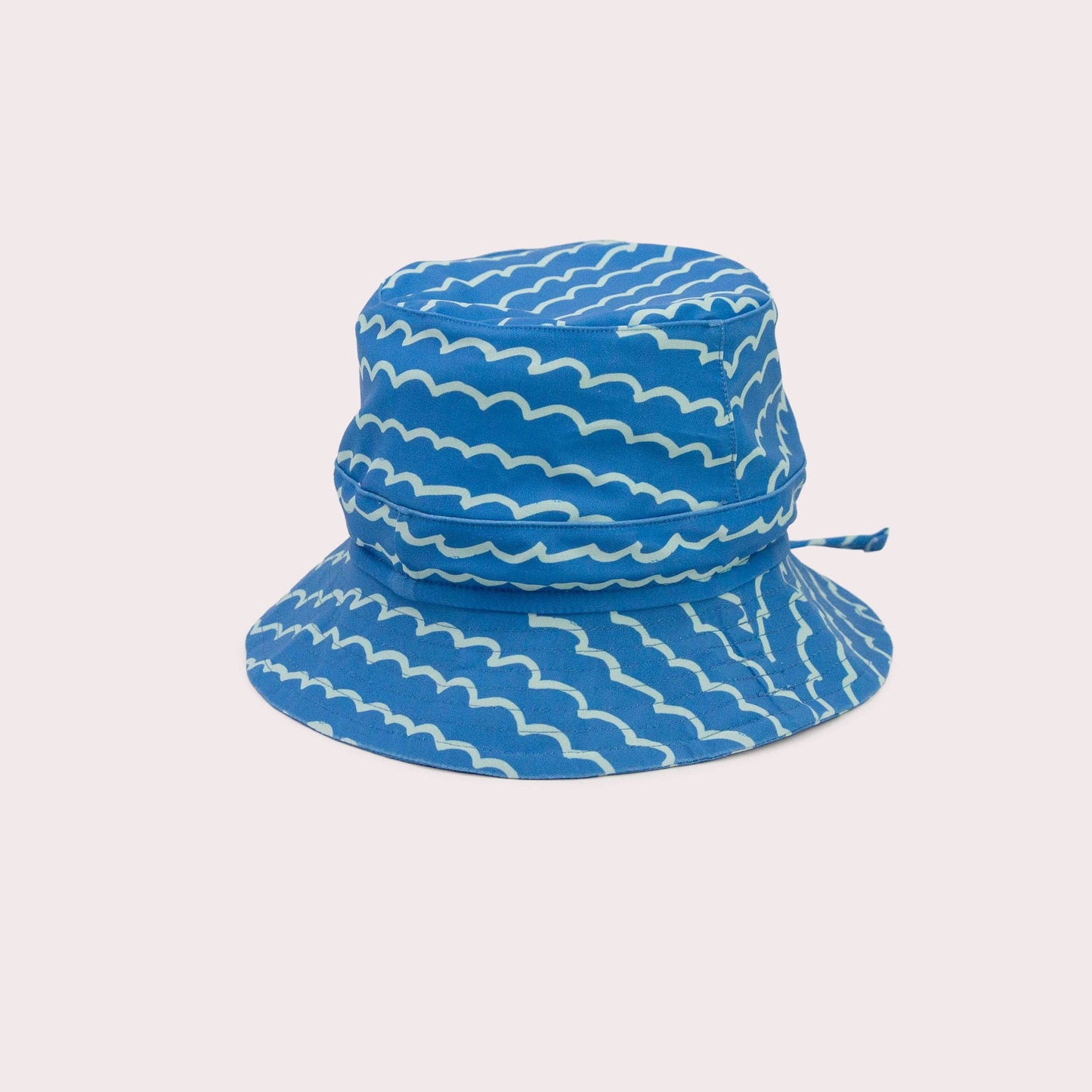 A beautiful lifestyle shot of Pacific Swim Hat: M (6-12 months) in beige, animal and brown by EcoNaps in a home setting.