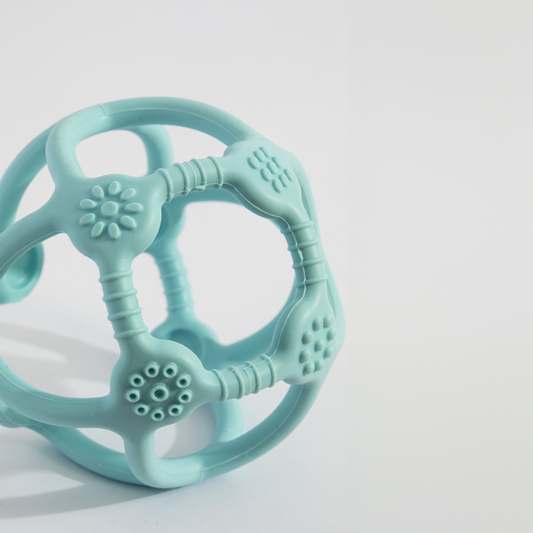 A close-up showing the soft textures and quality craftsmanship of the Playground Silicone Teething Ball - Light Blue.