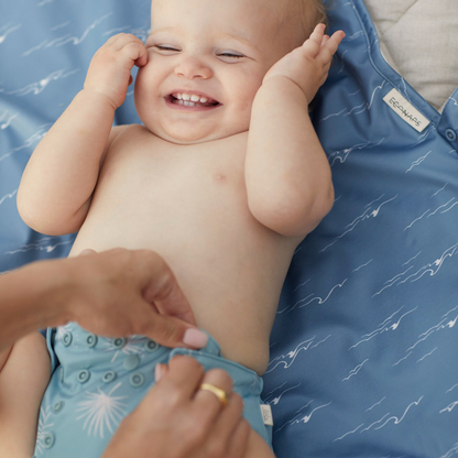The Desert Moon Change Mat: Desert Moon in beige, animal and brown styled beautifully on a shelf in a child's bedroom.