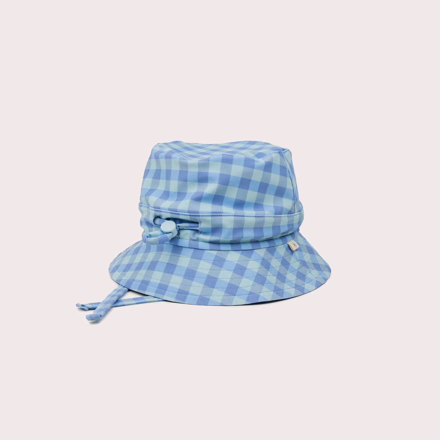 A beautiful lifestyle shot of Sky Swim Hat: M (6-12 months) in beige, animal and brown by EcoNaps in a home setting.