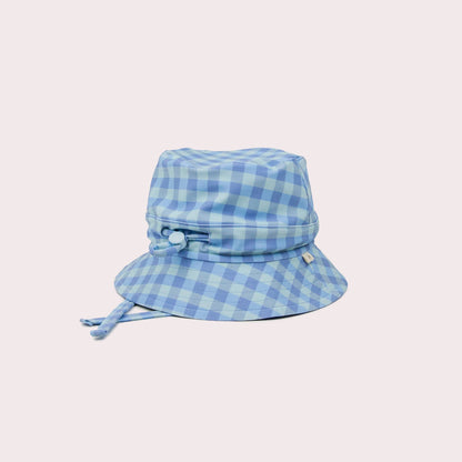 A beautiful lifestyle shot of Sky Swim Hat: M (6-12 months) in beige, animal and brown by EcoNaps in a home setting.