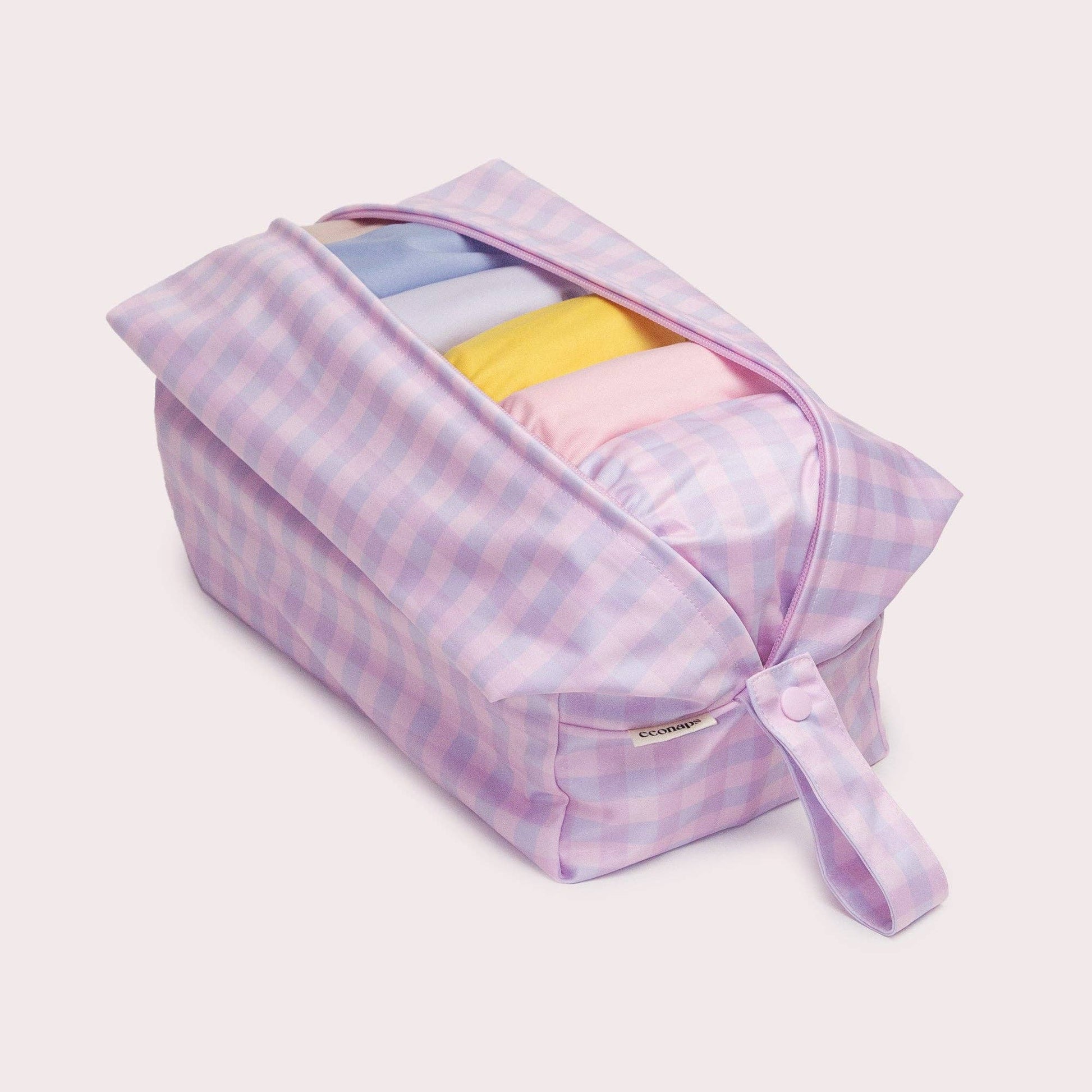 A beautiful lifestyle shot of Lilac Pod Wet bag in beige, animal and brown by EcoNaps in a home setting.