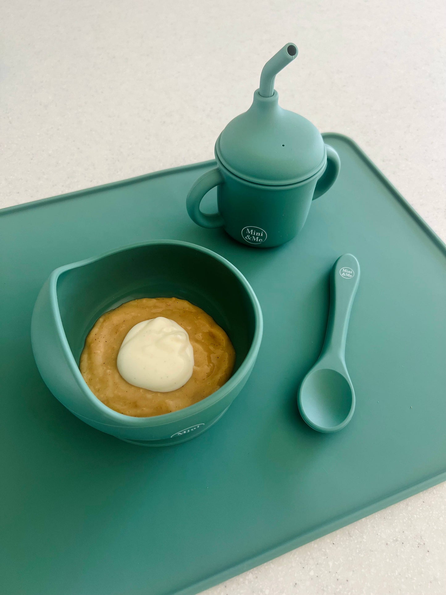 The Mini & Me Wave Bowl & Spoon Kale in beige, animal and brown styled beautifully on a shelf in a child's bedroom.