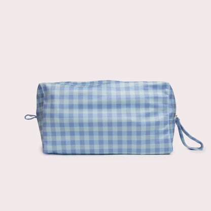 The Sky Pod Wet Bag in beige, animal and brown styled beautifully on a shelf in a child's bedroom.