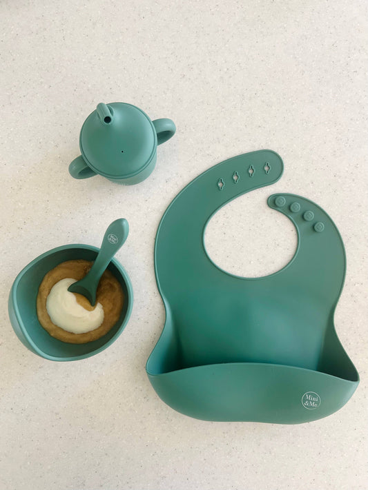 A beautiful lifestyle shot of Mini & Me Bib in almond, ice-blue and kale-green by Cuddle Bug & Co in a home setting.
