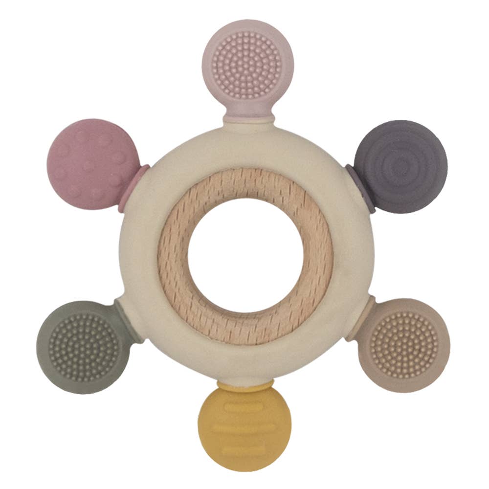 A beautiful lifestyle shot of Multi-Surface Teething Wheel - Rose by Living Textiles in a home setting.