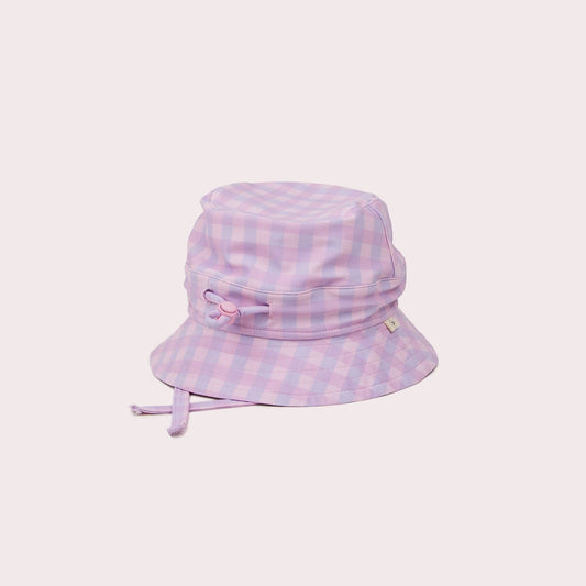 A beautiful lifestyle shot of Lilac Swim Hat: M (6-12 months) in beige, animal and brown by EcoNaps in a home setting.
