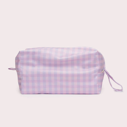 The Lilac Pod Wet bag in beige, animal and brown styled beautifully on a shelf in a child's bedroom.