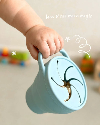 A toddler focused intently on independent play on a soft, natural fiber rug. Tiny Moments Co