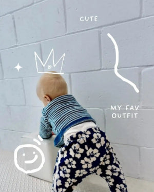 Adorable baby in a cute outfit enjoying a calm moment at home
