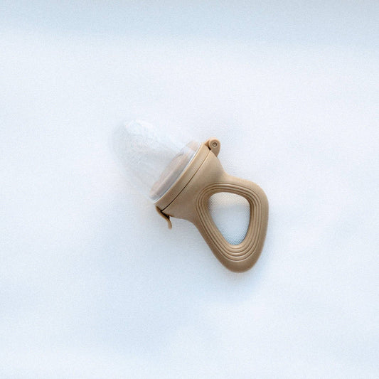 A beautiful lifestyle shot of Baby Feeder Terracotta by La Luna Kids in a home setting.