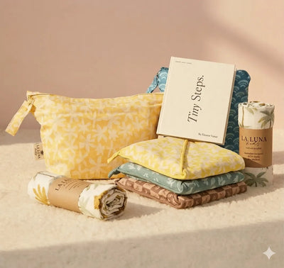 Product set with yellow pouch, folded items, and a book titled 'Tiny Steps' on a beige background.