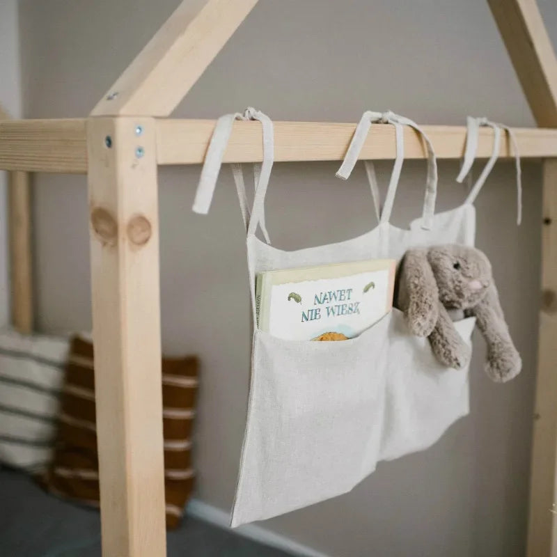Linen nursery organiser showing two spacious pockets for baby items