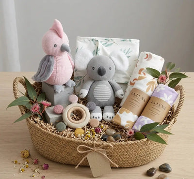 Stunning knitted toys, swaddles, change mat, and teether in a gift basket for newborns with flowers and decoration. - Tiny Moments Co
