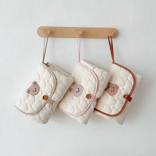 Foldable baby changing mat with waterproof backing - compact design