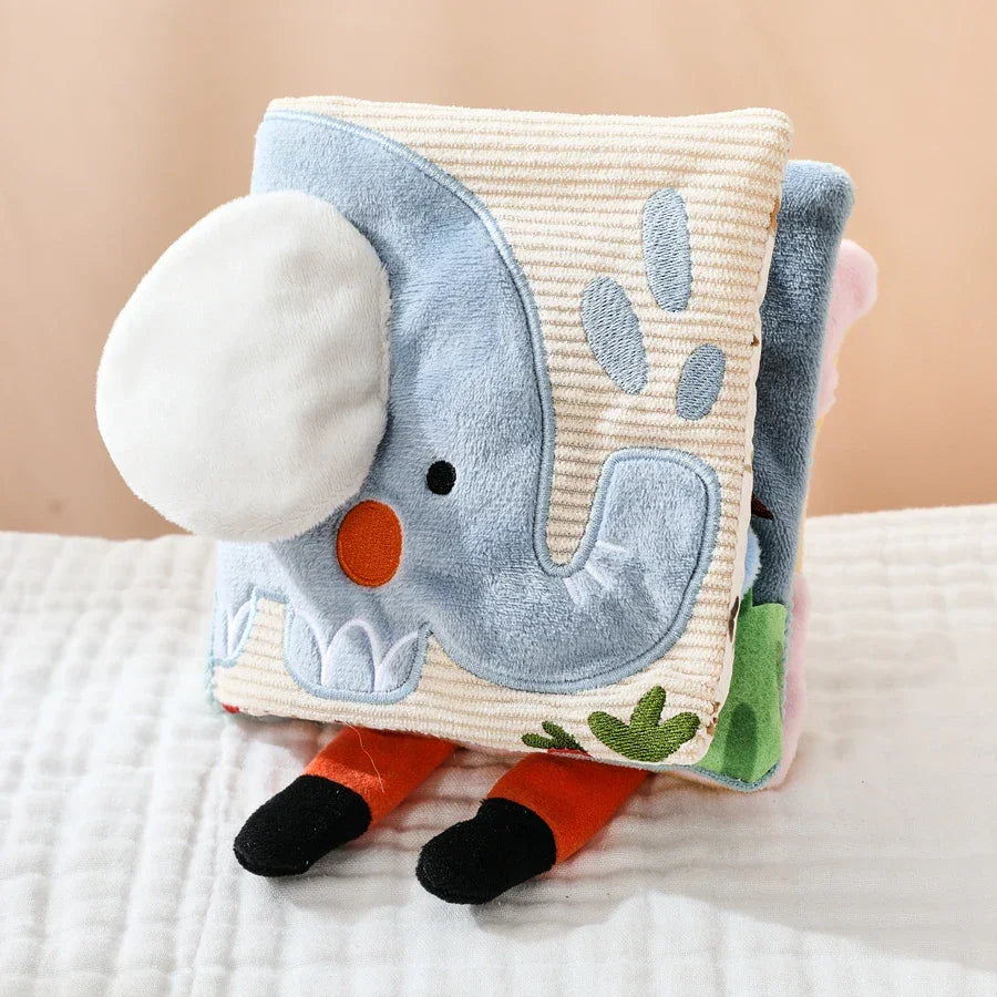Sensory cloth book showing animal pages and interactive mirror feature