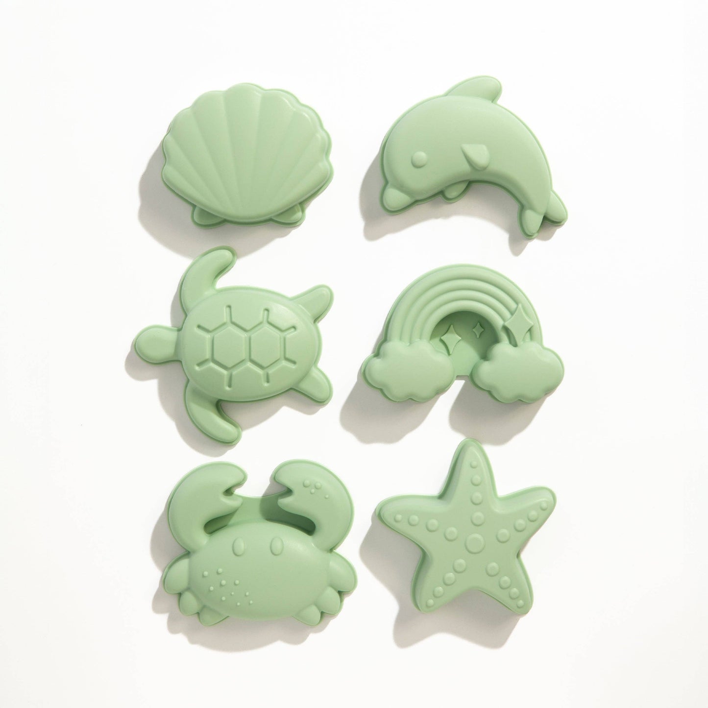 The 8pc Silicone Bucket Set - Light Sage styled beautifully on a shelf in a child's bedroom.