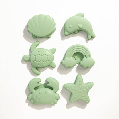 The 8pc Silicone Bucket Set - Light Sage styled beautifully on a shelf in a child's bedroom.