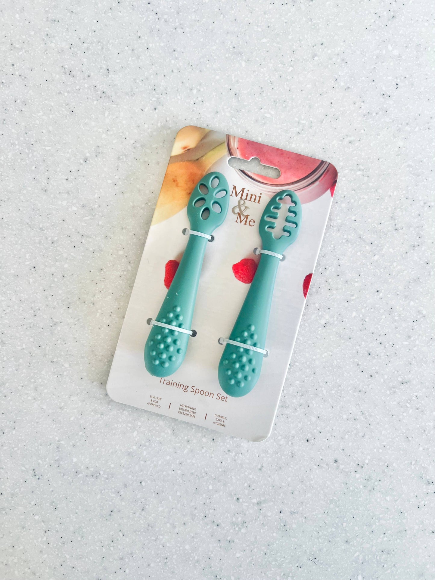 A beautiful lifestyle shot of Mini & Me Training Spoon Set Kale in almond, ice-blue and kale-green by Cuddle Bug & Co in a...