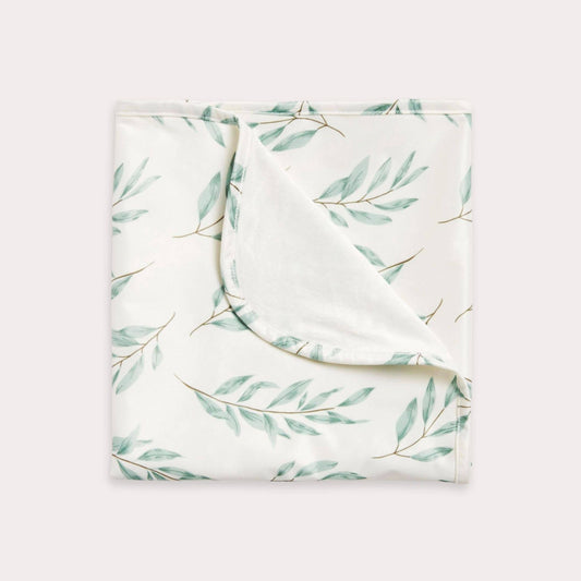 A beautiful lifestyle shot of Olive Leaf Change Mat: Olive Leaf in beige, animal and brown by EcoNaps in a home setting.