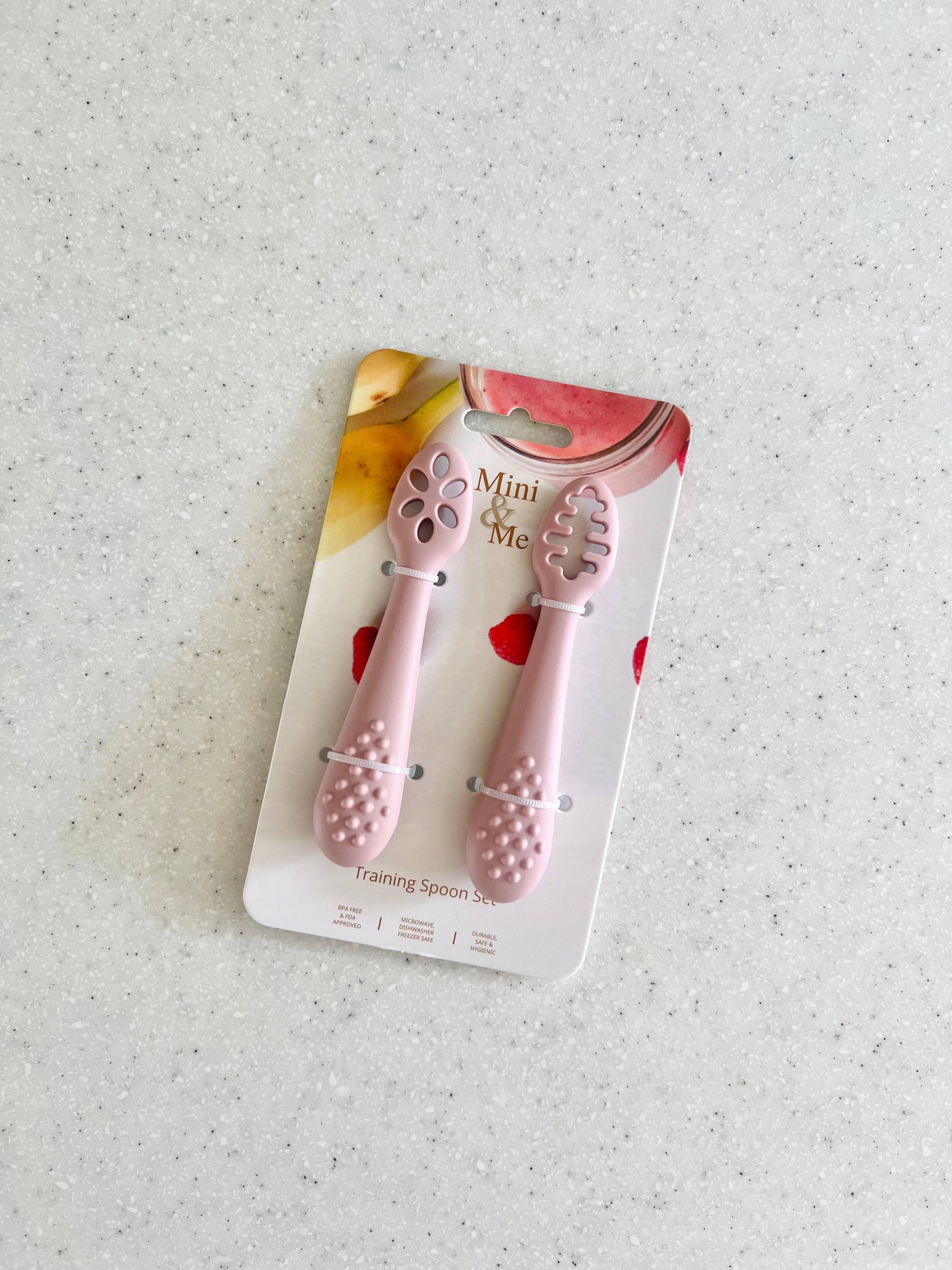 A beautiful lifestyle shot of Mini & Me Training Spoon Set Cherry in beige, animal and brown by Cuddle Bug & Co in a home ...