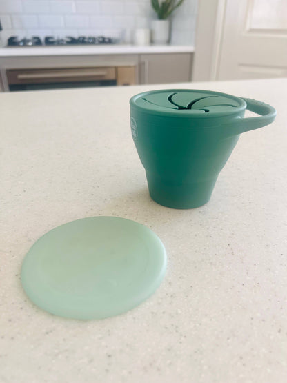 A close-up showing the soft textures and quality craftsmanship of the Mini & Me Snack Cup Collapsible with Lid Kale.