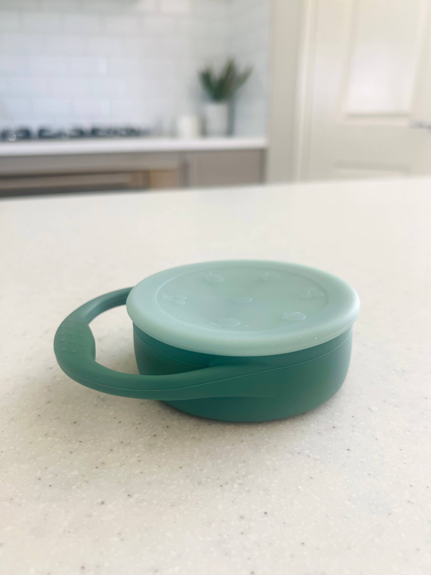 A beautiful lifestyle shot of Mini & Me Snack Cup Collapsible with Lid Kale in almond, ice-blue and kale-green by Cuddle B...