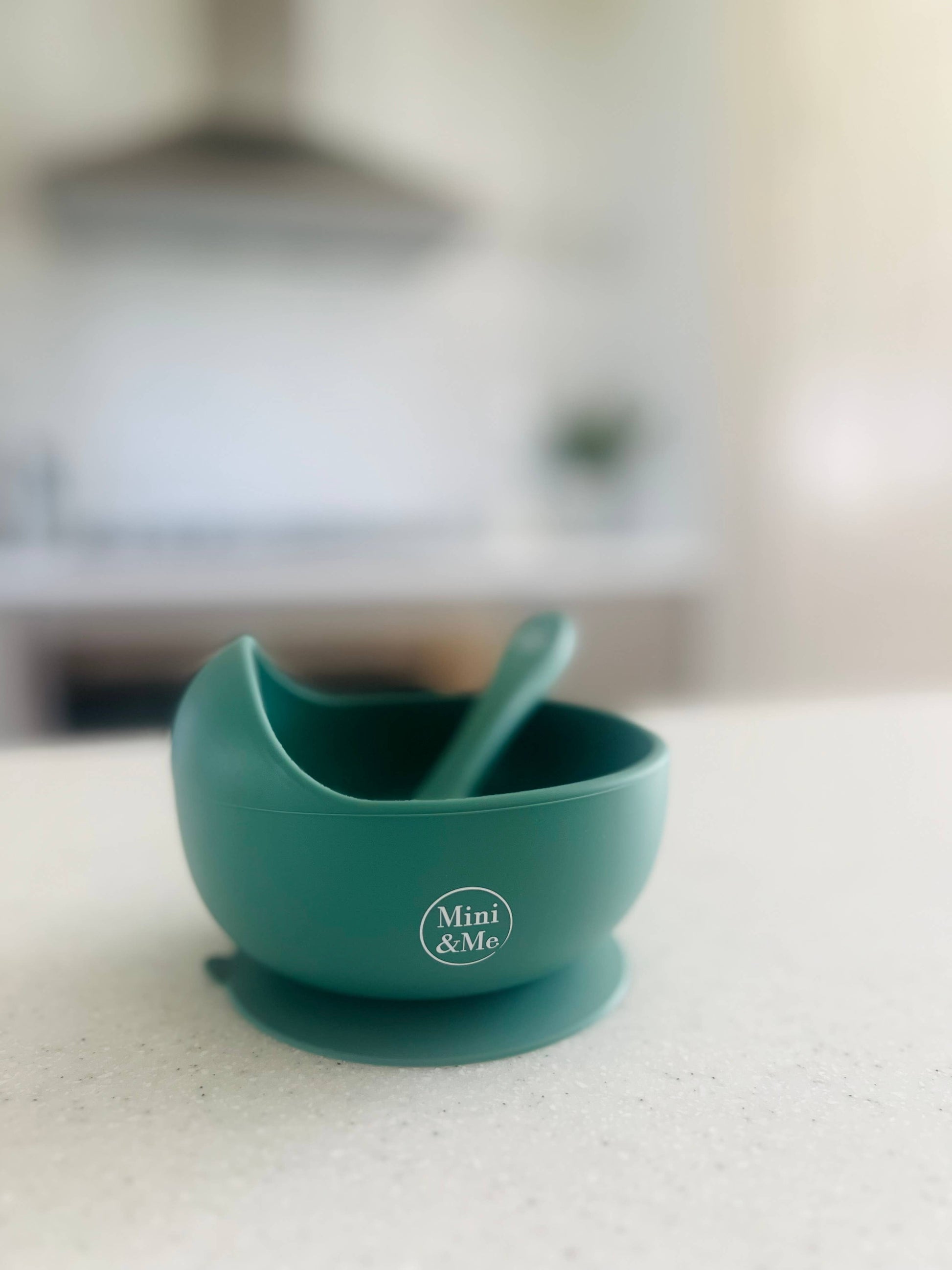 A beautiful lifestyle shot of Mini & Me Wave Bowl & Spoon Kale in beige, animal and brown by Cuddle Bug & Co in a home set...