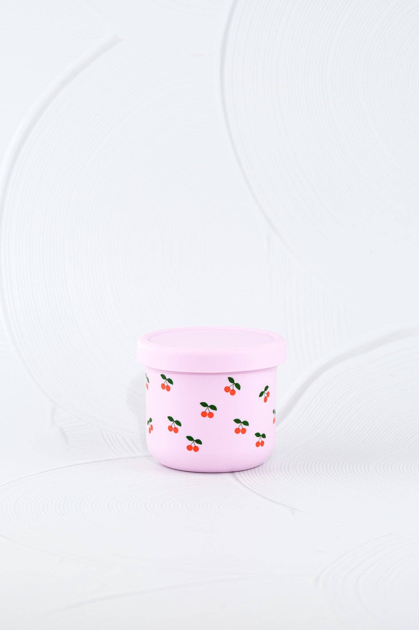 The Cherub Silicone SNACK POT styled beautifully on a shelf in a child's bedroom.