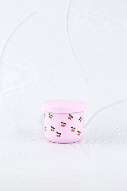 The Cherub Silicone SNACK POT styled beautifully on a shelf in a child's bedroom.