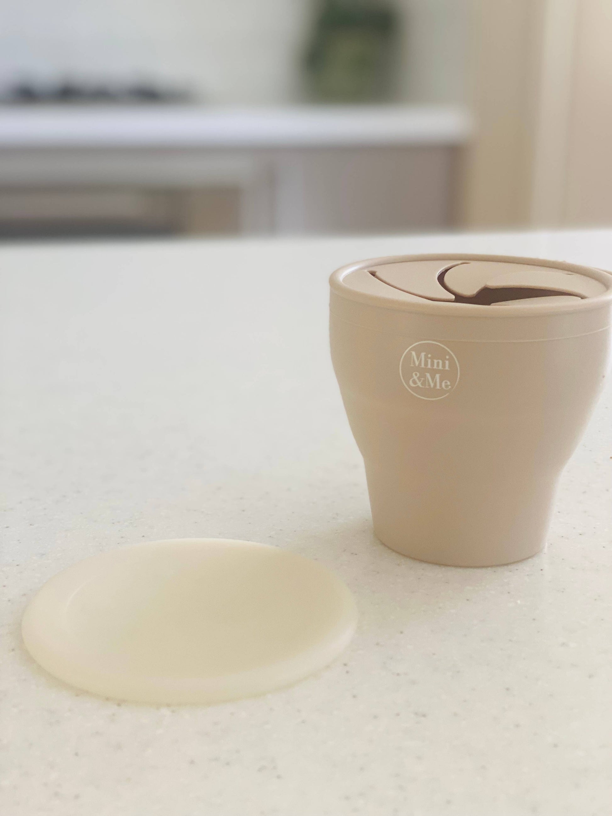 A close-up showing the soft textures and quality craftsmanship of the Mini & Me Snack Cup Collapsible with Lid Almond.